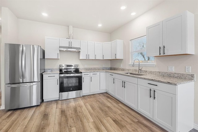 kitchen featuring sink, light hardwood / wood-style flooring, appliances with stainless steel finishes, light stone counters, and white cabinetry