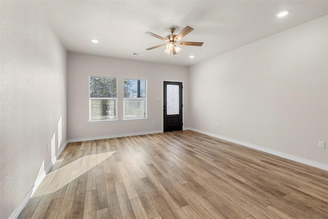 empty room featuring light wood-type flooring and ceiling fan