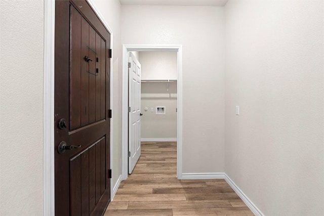 hall with light hardwood / wood-style flooring