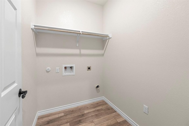 laundry room with hardwood / wood-style floors, electric dryer hookup, hookup for a gas dryer, and hookup for a washing machine