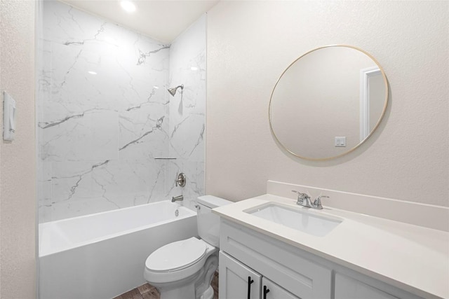 full bathroom with vanity, tiled shower / bath combo, and toilet