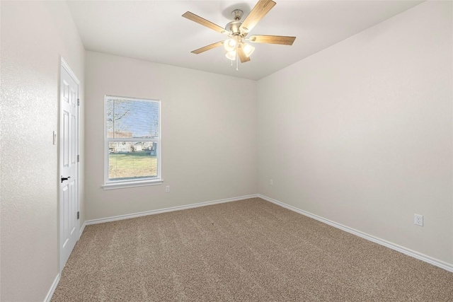 spare room featuring ceiling fan and carpet floors