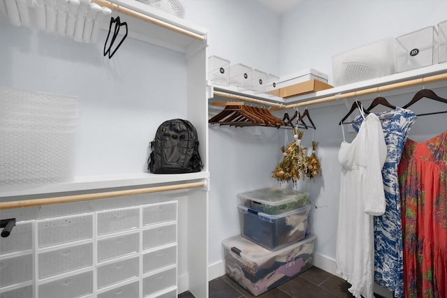 spacious closet featuring dark tile patterned flooring