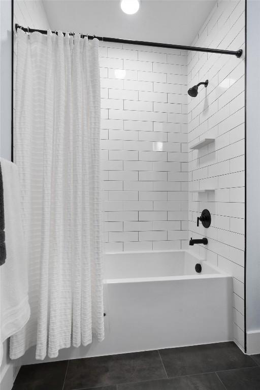 bathroom with tile patterned floors and shower / bath combo