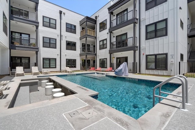 view of pool with pool water feature and a patio area