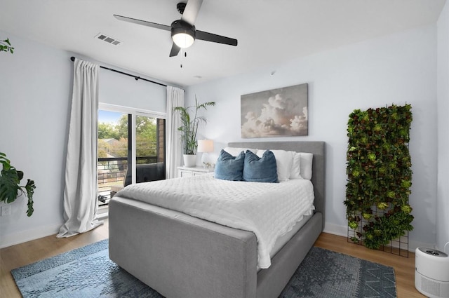 bedroom featuring access to exterior, ceiling fan, and hardwood / wood-style floors