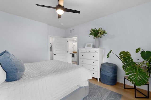 bedroom with ceiling fan and light hardwood / wood-style floors