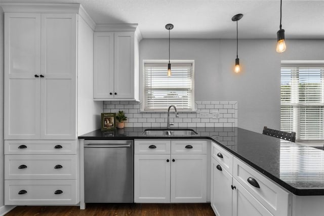 kitchen featuring dishwasher, white cabinetry, and decorative light fixtures