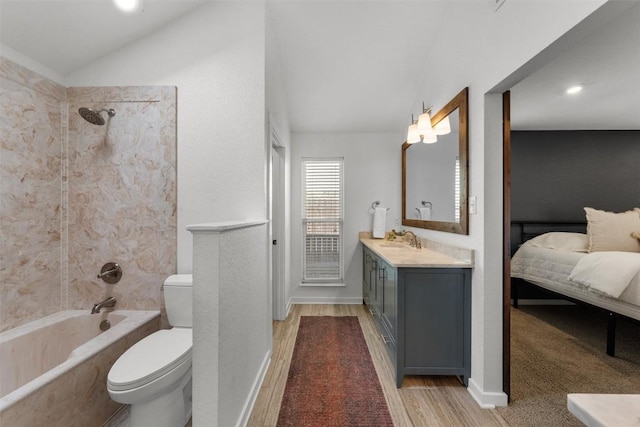 full bathroom featuring tiled shower / bath combo, wood-type flooring, lofted ceiling, toilet, and vanity