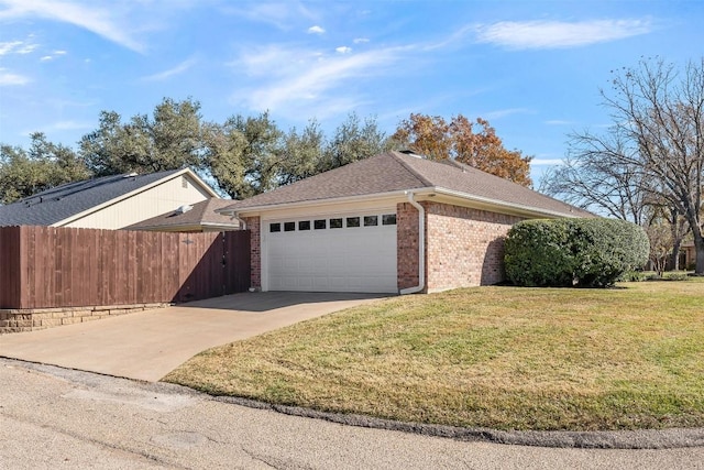 view of side of property with a lawn and a garage