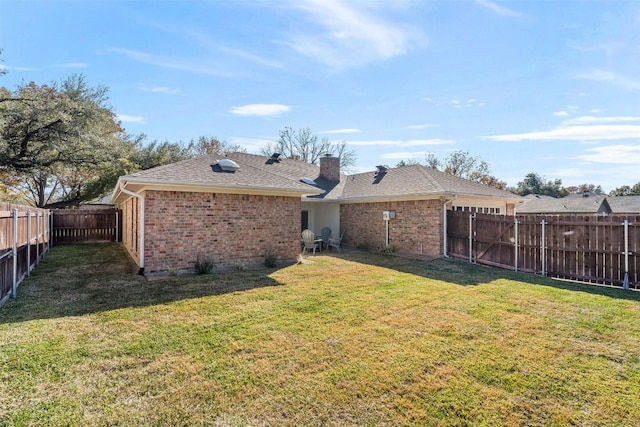 rear view of house with a lawn