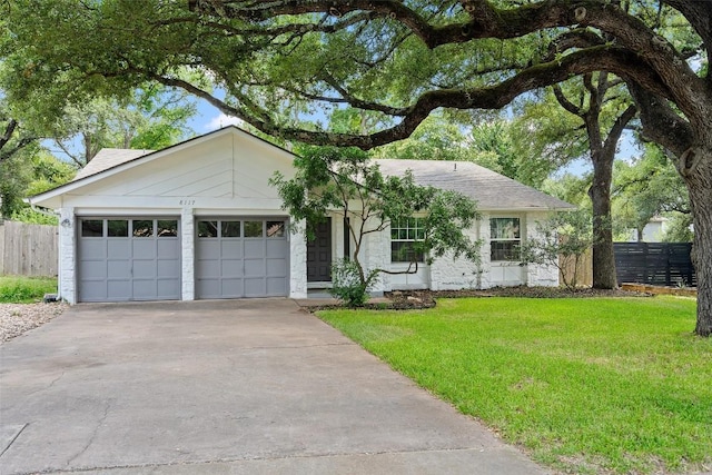 single story home with a front yard and a garage