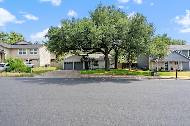 view of front of property featuring cooling unit and a garage