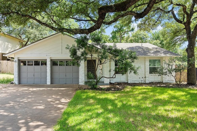 ranch-style home with a front lawn and a garage