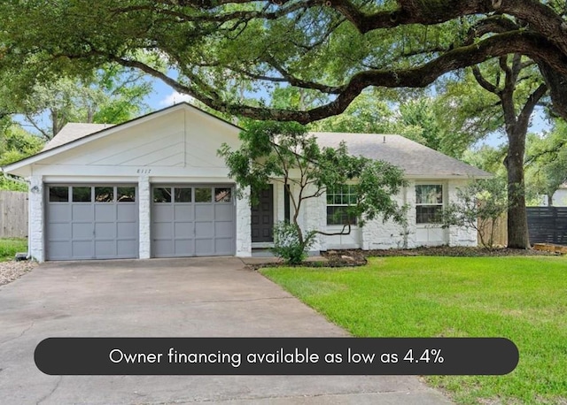 single story home with a garage and a front lawn