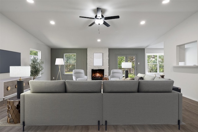 living room with ceiling fan, dark wood-type flooring, and vaulted ceiling