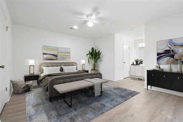 bedroom featuring connected bathroom, ceiling fan, and light hardwood / wood-style flooring