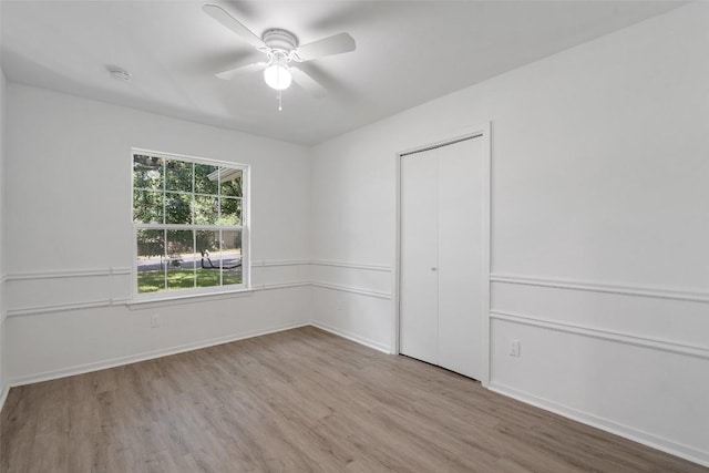 empty room featuring ceiling fan and light wood-type flooring