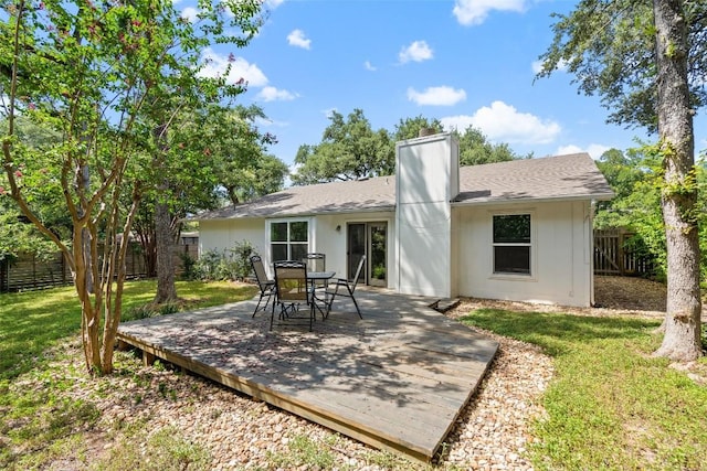 rear view of property featuring a yard