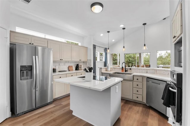 210 Finn St, Austin, TX 78734 - kitchen with stainless steel appliances, a sink, backsplash, a peninsula, and a kitchen island