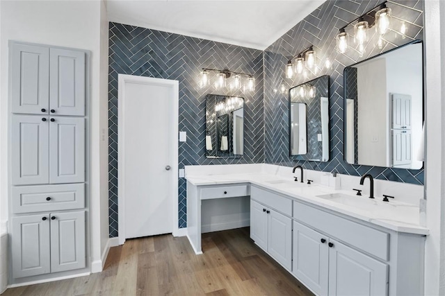 bathroom with hardwood / wood-style floors, vanity, and tile walls