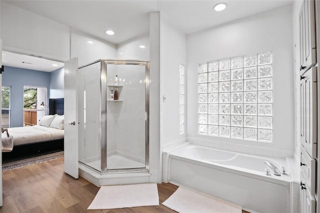 bathroom with separate shower and tub and hardwood / wood-style floors