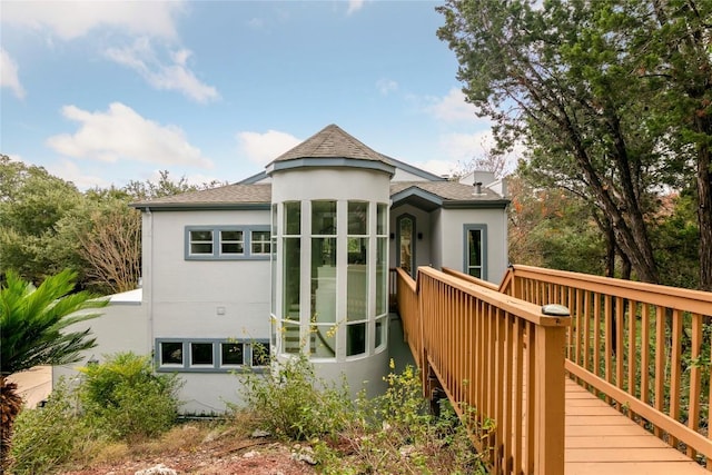 210 Finn St, Austin, TX 78734 - view of front of home featuring stucco siding, a shingled roof, and a deck