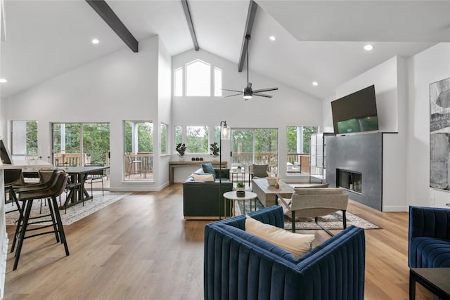 210 Finn St, Austin, TX 78734 - living room featuring a glass covered fireplace, beamed ceiling, a ceiling fan, high vaulted ceiling, and light wood-style floors