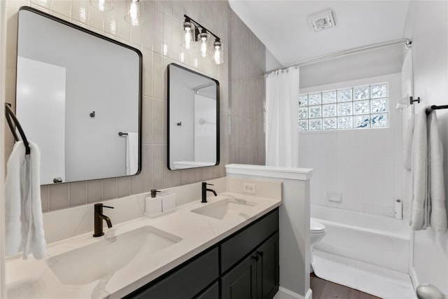 full bathroom with vanity, hardwood / wood-style flooring, toilet, and shower / bathtub combination with curtain