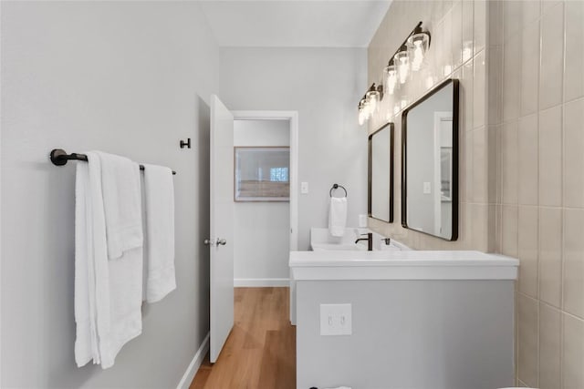 210 Finn St, Austin, TX 78734 - bathroom featuring vanity, wood finished floors, and baseboards