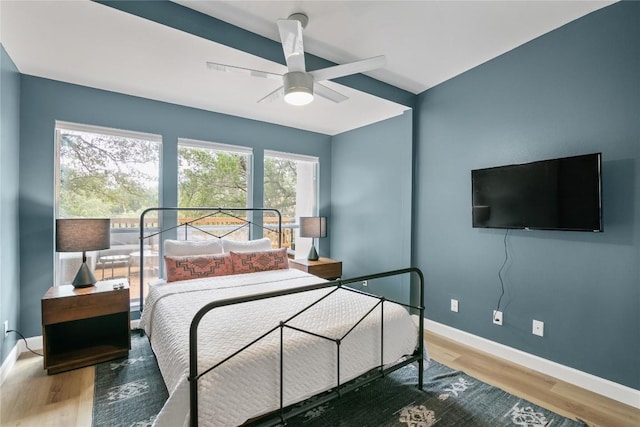 bedroom with hardwood / wood-style floors and ceiling fan