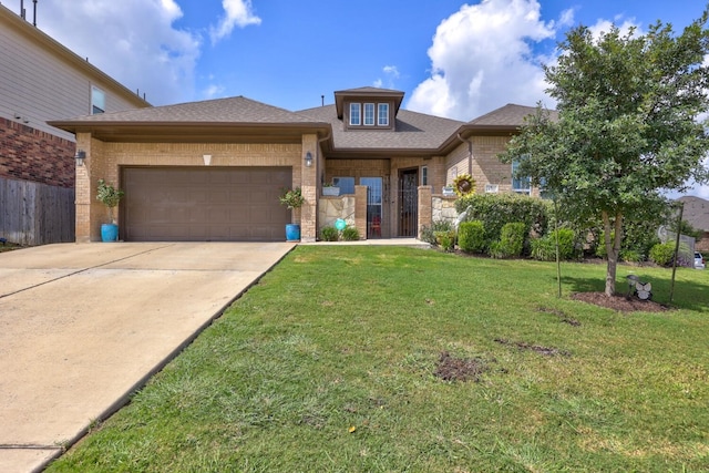 view of front of house featuring a garage and a front yard