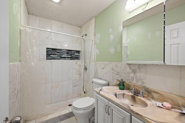 bathroom featuring curtained shower, vanity, a textured ceiling, and toilet