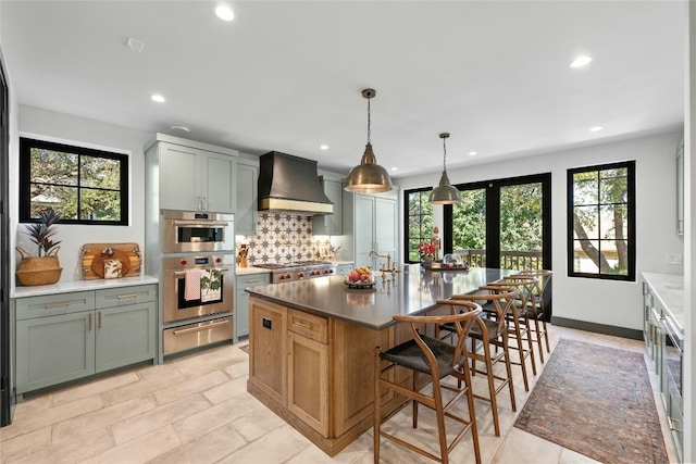 kitchen featuring custom exhaust hood, a wealth of natural light, double oven, and tasteful backsplash