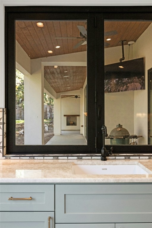 bathroom with vanity and wood ceiling