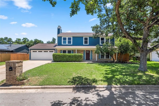 view of front of house with a garage and a front lawn