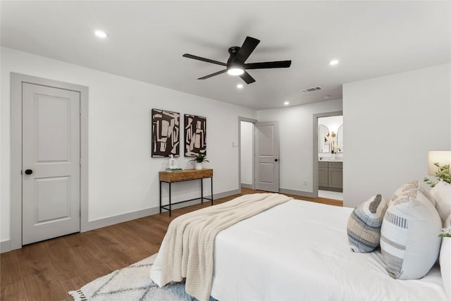 bedroom featuring hardwood / wood-style flooring, ensuite bath, and ceiling fan