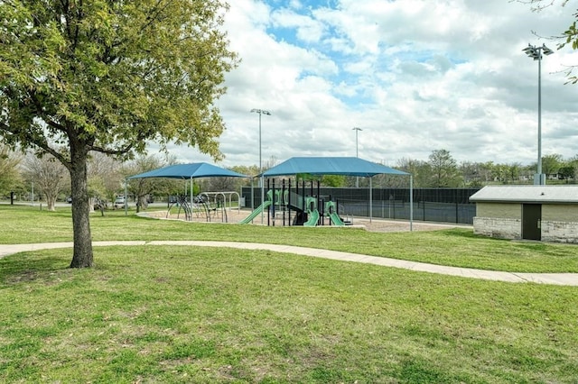 view of home's community with a playground and a lawn