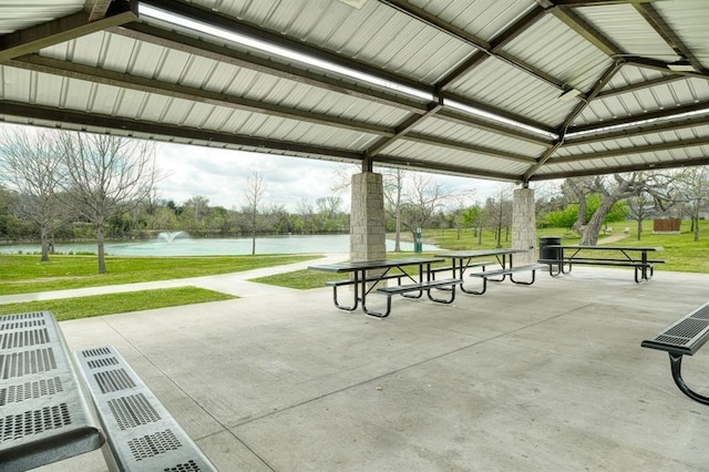 view of property's community with a gazebo, a yard, and a water view