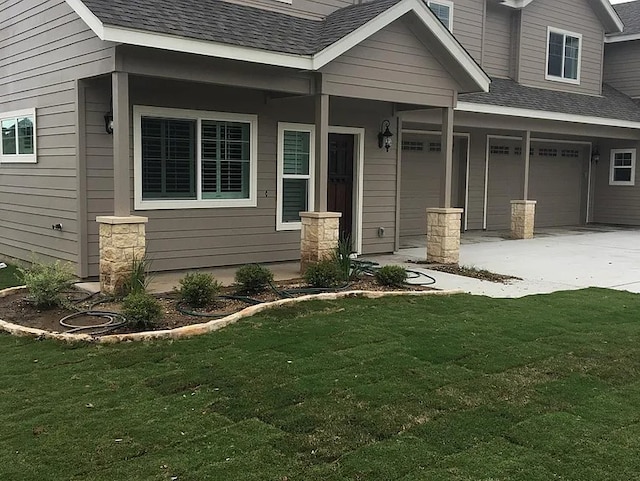 property entrance featuring a yard and a garage