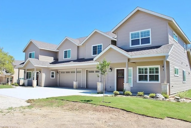 view of front of house with a garage and a front lawn