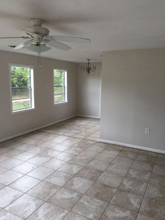5217/5215 Bell Springs Rd, Dripping Springs, TX 78620 - empty room with baseboards, ceiling fan, and light tile patterned floors