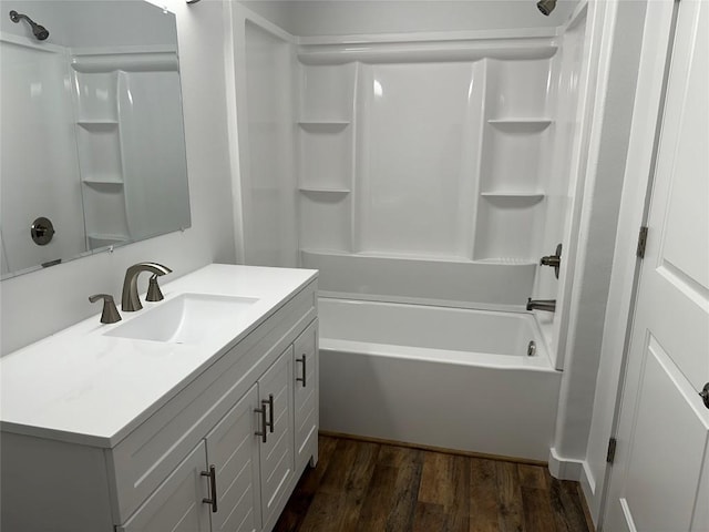 bathroom with bathtub / shower combination, hardwood / wood-style floors, and vanity