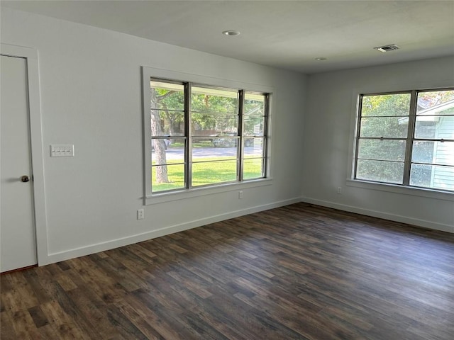 spare room featuring dark wood-type flooring