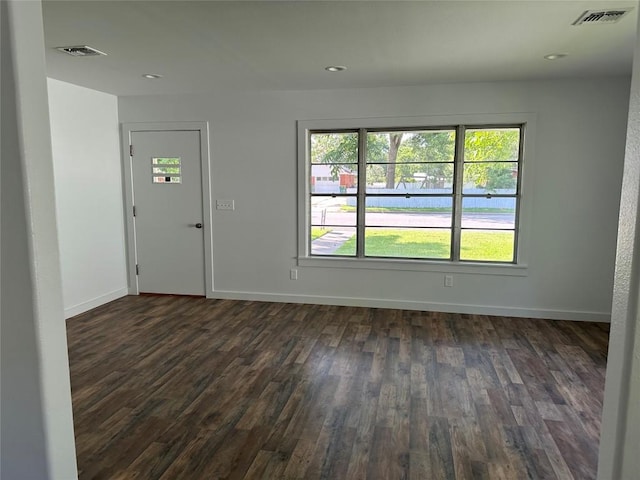 unfurnished room with dark hardwood / wood-style flooring