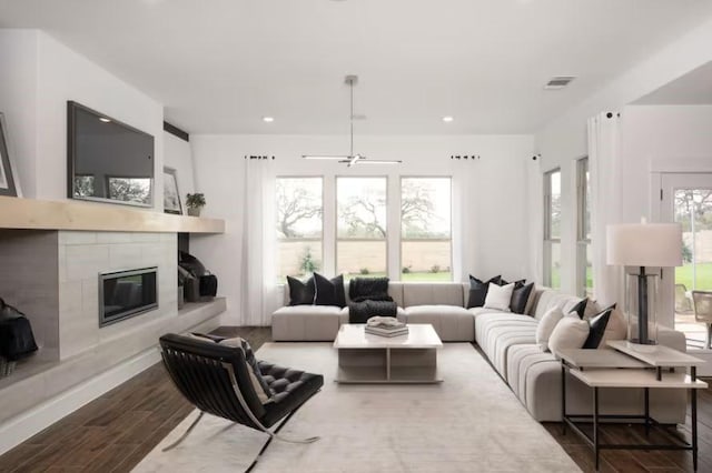 living room featuring ceiling fan and hardwood / wood-style flooring