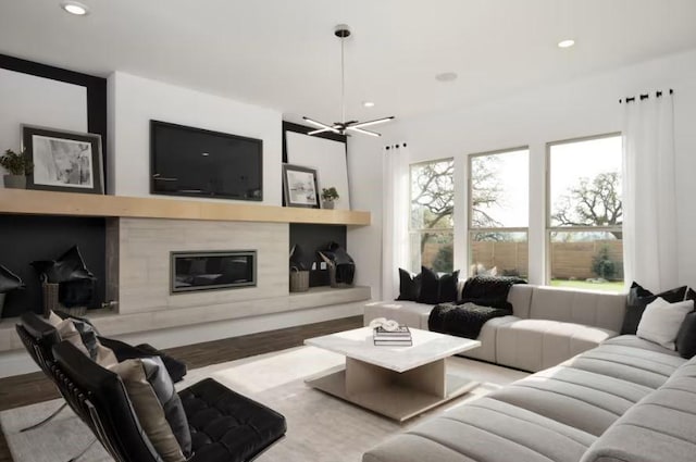 living room featuring hardwood / wood-style flooring, a healthy amount of sunlight, and a fireplace