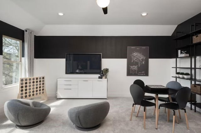 living room featuring ceiling fan and vaulted ceiling