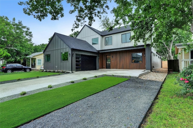 view of front of home with a garage and a front lawn