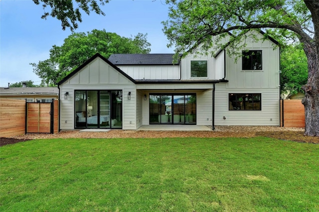 rear view of property with a patio area and a yard